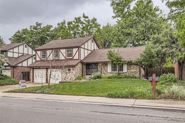 2556 S Eagle Cir, Aurora, CO 80014 - tudor home featuring a garage, brick siding, driveway, and a shingled roof