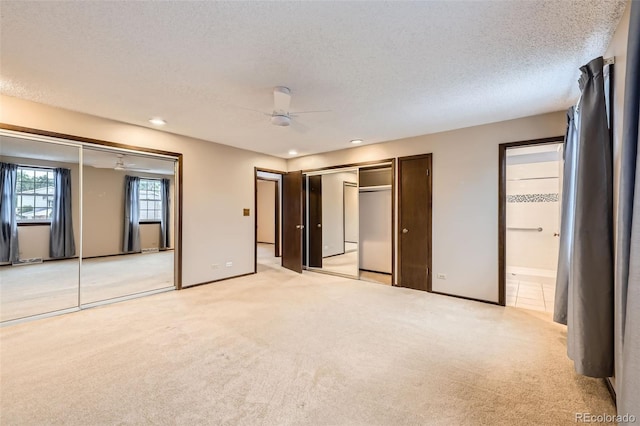 2556 S Eagle Cir, Aurora, CO 80014 - unfurnished bedroom featuring light carpet, a textured ceiling, two closets, recessed lighting, and baseboards