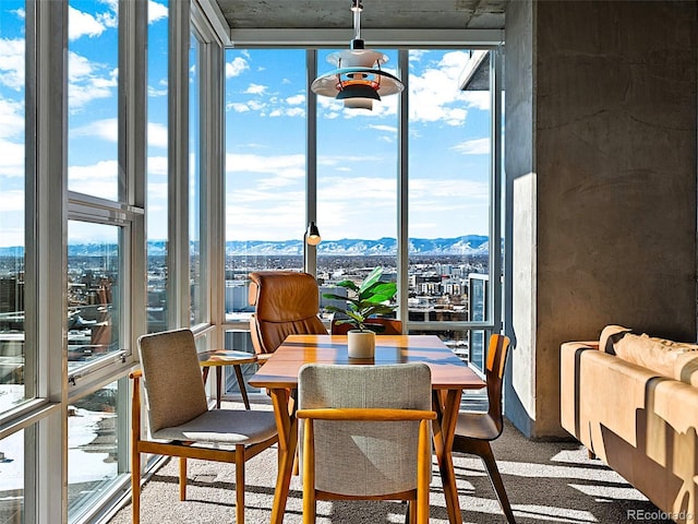 sunroom with a mountain view and a healthy amount of sunlight