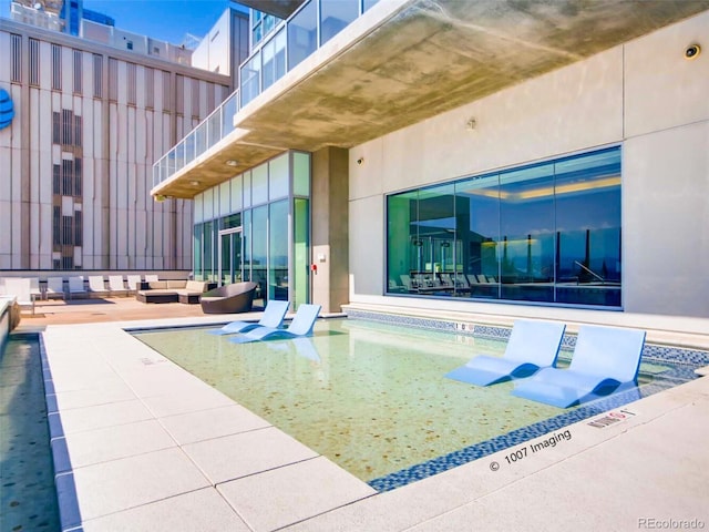 view of swimming pool with a patio