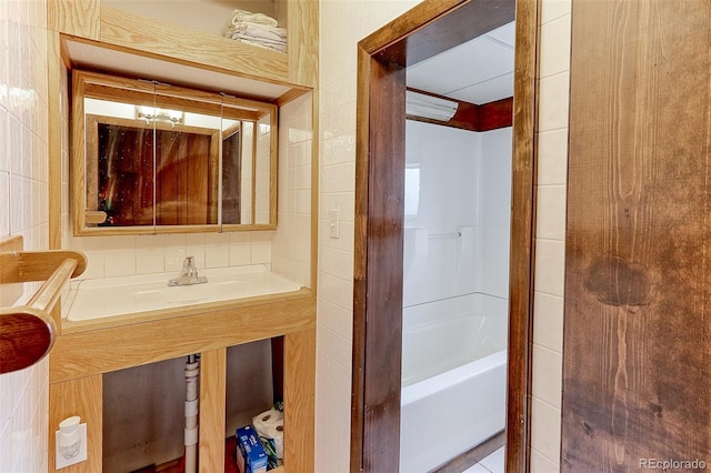 bathroom featuring a bathing tub, a shower, and tile walls