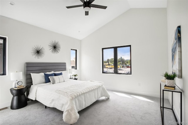 carpeted bedroom featuring high vaulted ceiling and ceiling fan