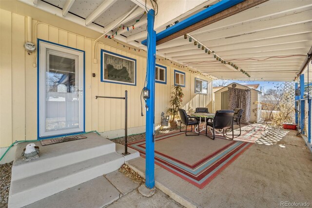 view of patio featuring a shed