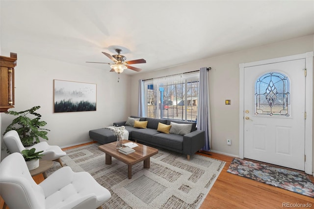 living room with hardwood / wood-style flooring and ceiling fan