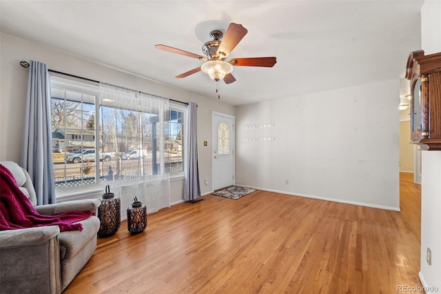 sitting room with light wood-type flooring and ceiling fan