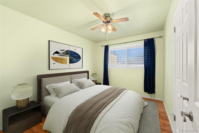 bedroom featuring ceiling fan and hardwood / wood-style floors