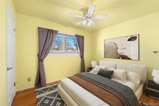 bedroom featuring hardwood / wood-style flooring and ceiling fan