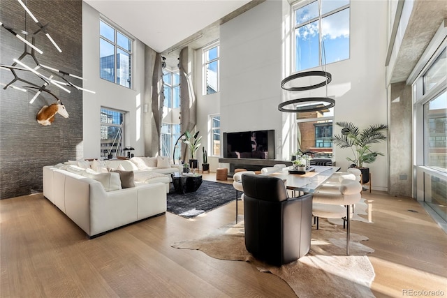 1610 Little Raven St Unit Ph6, Denver, CO 80202 - living area featuring a towering ceiling and wood finished floors