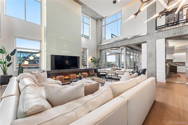 1610 Little Raven St Unit Ph6, Denver, CO 80202 - living area with a towering ceiling and wood finished floors