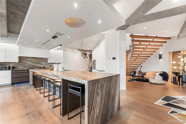 1610 Little Raven St Unit Ph6, Denver, CO 80202 - kitchen featuring modern cabinets, light wood finished floors, white cabinets, and recessed lighting