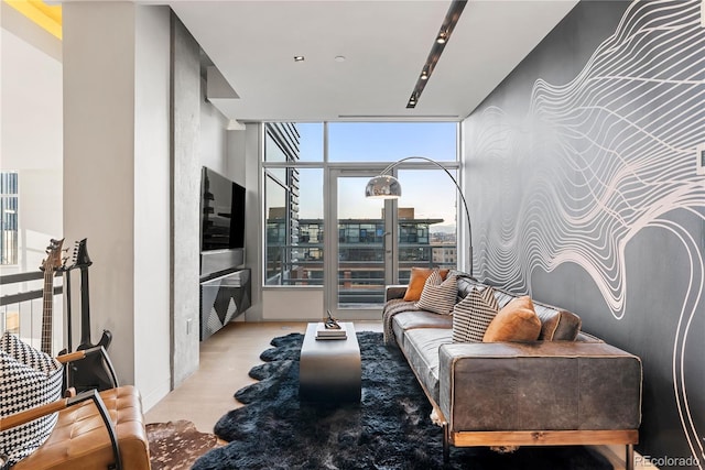 1610 Little Raven St Unit Ph6, Denver, CO 80202 - living area featuring a wall of windows, light wood-style flooring, baseboards, and an accent wall