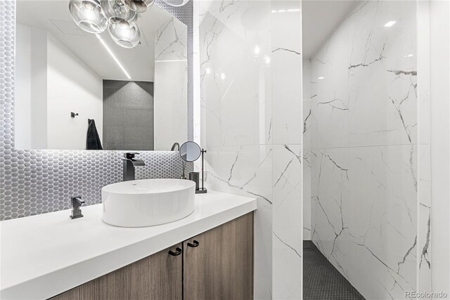 1610 Little Raven St Unit Ph6, Denver, CO 80202 - bathroom featuring tile walls, backsplash, and vanity