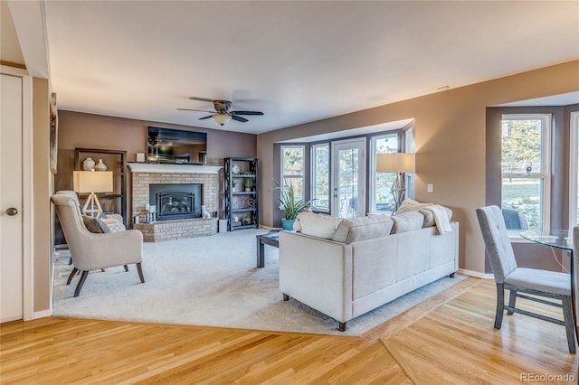 14915 Gleneagle Dr, Colorado Springs, CO 80921 - living room featuring a ceiling fan, light wood finished floors, baseboards, and a fireplace