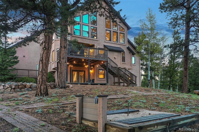 2100 Elk Rdg, Divide, CO 80814 - view of front of property featuring stairs, a wooden deck, stucco siding, and french doors