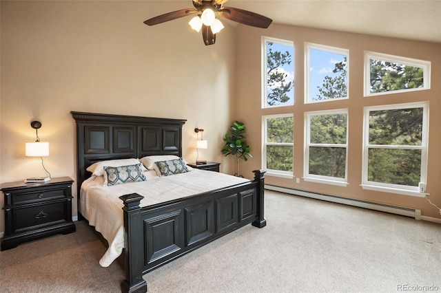 2100 Elk Rdg, Divide, CO 80814 - bedroom featuring light colored carpet, a baseboard radiator, and a ceiling fan