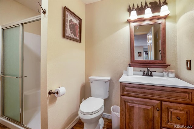 2100 Elk Rdg, Divide, CO 80814 - full bath with vanity, a stall shower, toilet, wood finished floors, and baseboards