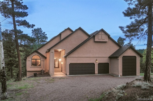 2100 Elk Rdg, Divide, CO 80814 - view of front of property featuring a garage, gravel driveway, and stucco siding