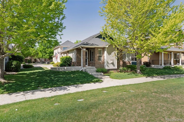 660 Callisto Dr, Loveland, CO 80537 - view of front of home featuring brick siding, a front yard, and covered porch