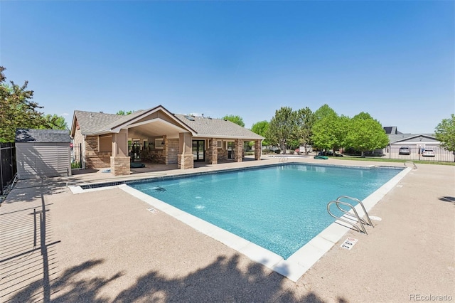 660 Callisto Dr, Loveland, CO 80537 - community pool with fence, a patio area, an outdoor structure, and a storage shed