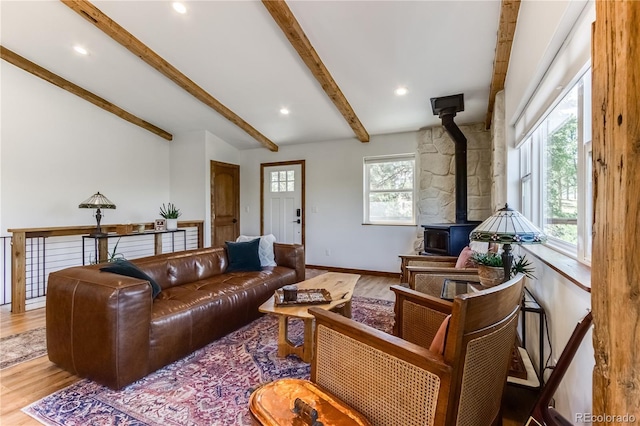 47 Wykagyl Cir, Westcliffe, CO 81252 - living area with a healthy amount of sunlight, a wood stove, beam ceiling, and wood finished floors