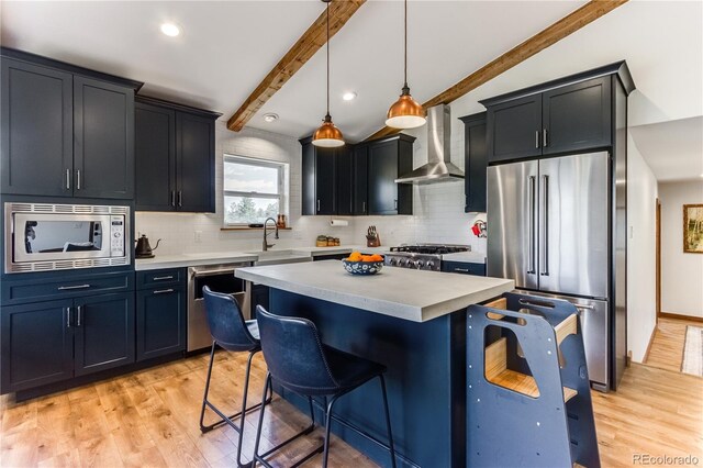 47 Wykagyl Cir, Westcliffe, CO 81252 - kitchen with wall chimney range hood, a kitchen bar, light countertops, a sink, and appliances with stainless steel finishes