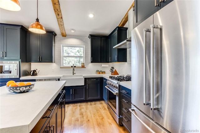 47 Wykagyl Cir, Westcliffe, CO 81252 - kitchen with high end appliances, tasteful backsplash, a sink, light countertops, and light wood-style flooring