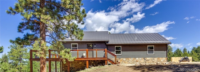 47 Wykagyl Cir, Westcliffe, CO 81252 - rear view of property featuring a deck, metal roof, and stone siding