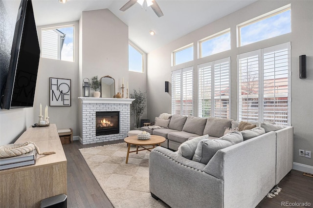 13340 Saint Paul St, Thornton, CO 80241 - living room with high vaulted ceiling, ceiling fan, a brick fireplace, and wood finished floors