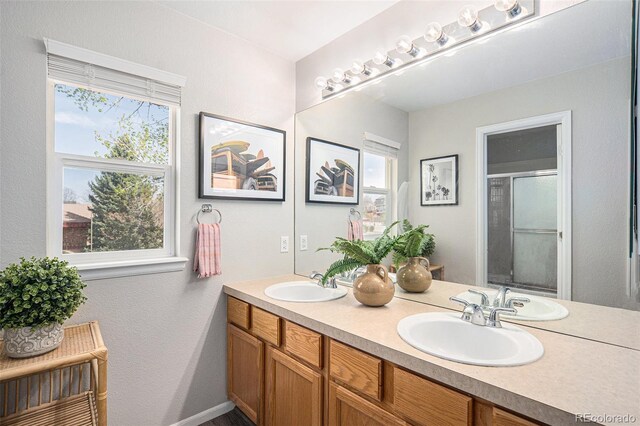 13340 Saint Paul St, Thornton, CO 80241 - bathroom featuring double vanity and an enclosed shower