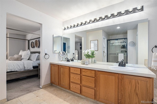 13340 Saint Paul St, Thornton, CO 80241 - full bath featuring double vanity, tile patterned floors, ensuite bathroom, and a shower