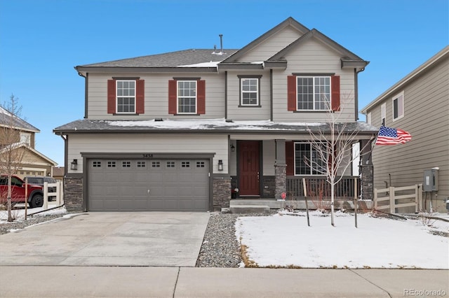 craftsman-style home with driveway, stone siding, an attached garage, fence, and a porch