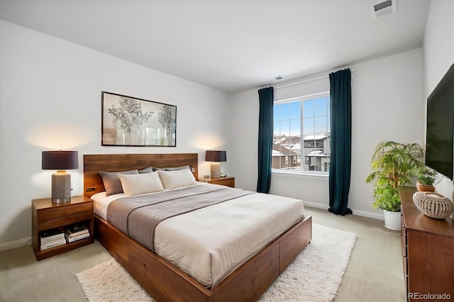 bedroom featuring light carpet, visible vents, and baseboards