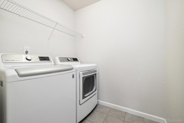 laundry room with light tile patterned floors, laundry area, independent washer and dryer, and baseboards