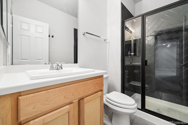 bathroom with toilet, a stall shower, tile patterned flooring, and vanity