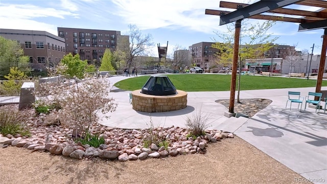 view of home's community with a patio area and a lawn