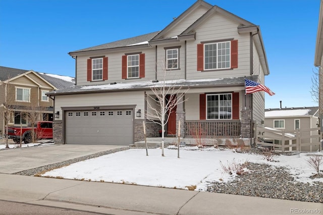 view of front of house featuring driveway, covered porch, an attached garage, and stone siding