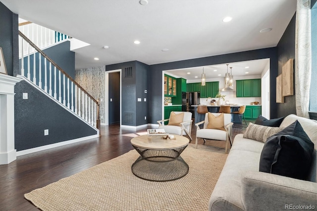 living room with visible vents, baseboards, dark wood-style floors, stairs, and recessed lighting