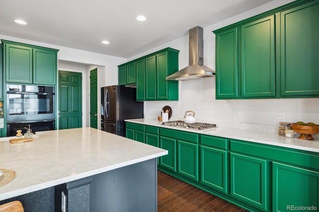 kitchen featuring wall chimney exhaust hood, appliances with stainless steel finishes, dark wood-style flooring, and recessed lighting