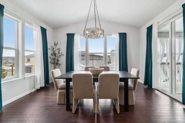 dining space with lofted ceiling, dark wood-type flooring, and a notable chandelier