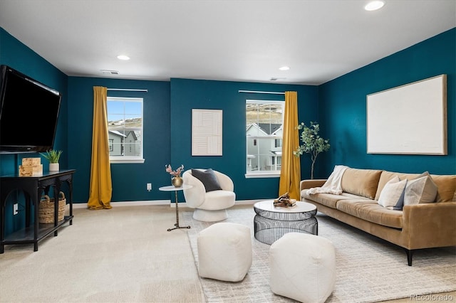 carpeted living area featuring recessed lighting, visible vents, and baseboards