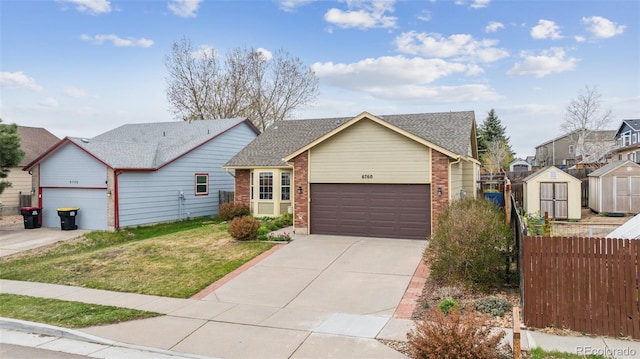 6760 Oakwood Blvd, Colorado Springs, CO 80923 - view of front facade with brick siding, driveway, and an attached garage