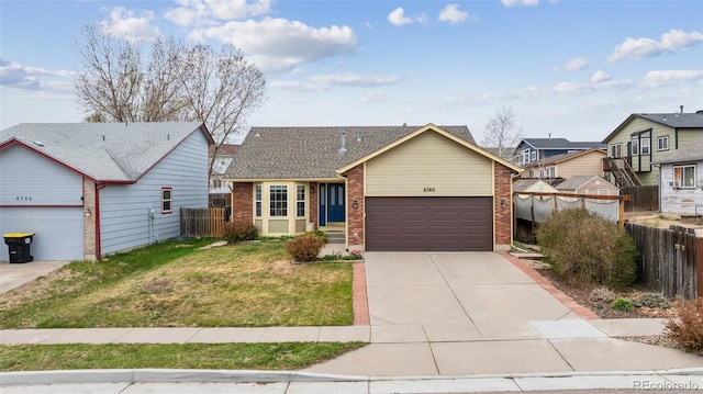 6760 Oakwood Blvd, Colorado Springs, CO 80923 - view of front of property featuring brick siding, an attached garage, and concrete driveway