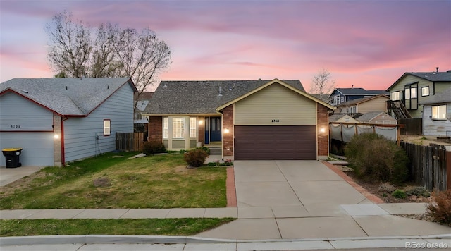 6760 Oakwood Blvd, Colorado Springs, CO 80923 - view of front of house featuring a garage, driveway, and brick siding