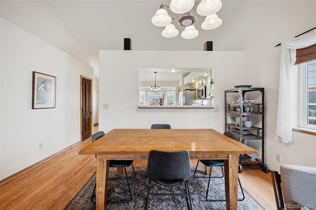 6760 Oakwood Blvd, Colorado Springs, CO 80923 - dining space featuring a chandelier, wood finished floors, and healthy amount of natural light