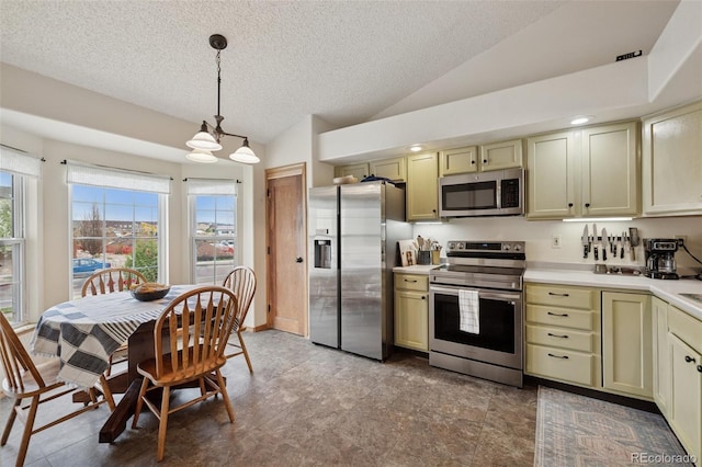 6760 Oakwood Blvd, Colorado Springs, CO 80923 - kitchen with appliances with stainless steel finishes, vaulted ceiling, a chandelier, light countertops, and a textured ceiling