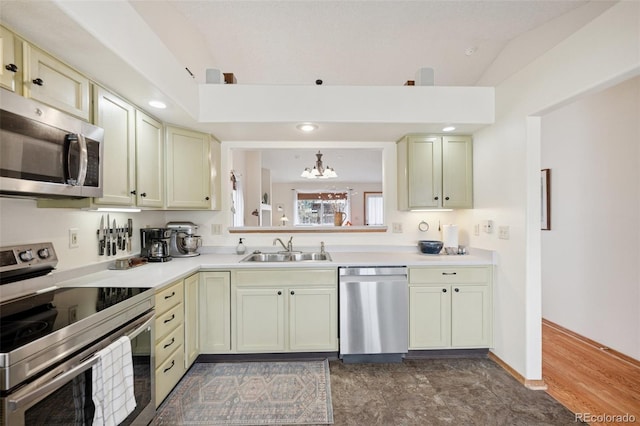 6760 Oakwood Blvd, Colorado Springs, CO 80923 - kitchen with stainless steel appliances, a sink, a chandelier, light countertops, and cream cabinetry