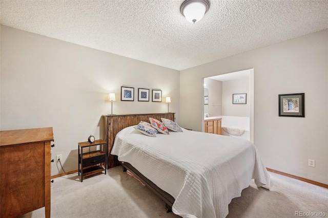 6760 Oakwood Blvd, Colorado Springs, CO 80923 - bedroom featuring carpet floors, baseboards, connected bathroom, and a textured ceiling