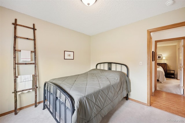 6760 Oakwood Blvd, Colorado Springs, CO 80923 - bedroom with carpet floors, baseboards, and a textured ceiling