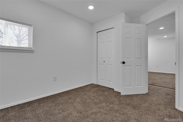 unfurnished bedroom with carpet floors and a closet