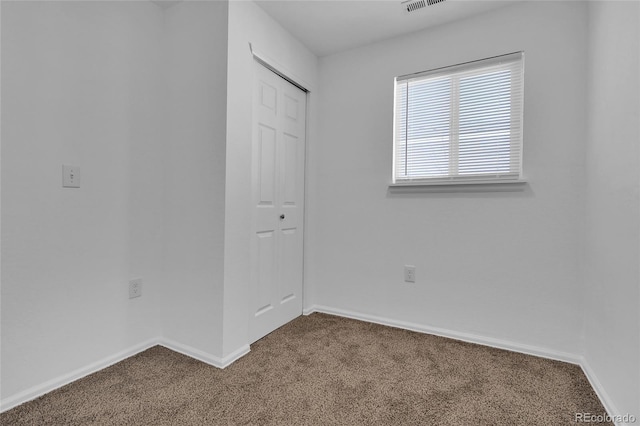 unfurnished bedroom with a closet and carpet